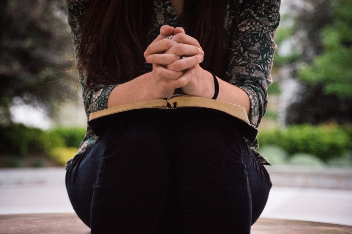 Jesus taught that His Church should keep the commandments of God. He knew that false teachers would arise who would reject the commandments of God for a distorted gospel of no law—lawlessness! A woman holding a Bible on her lap.