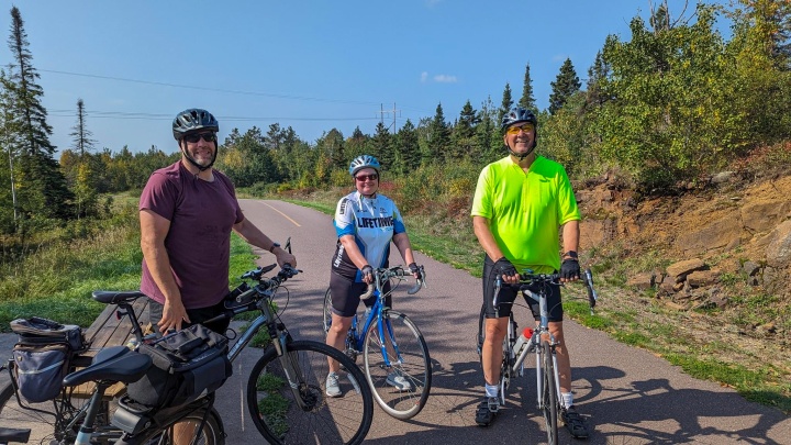 Join us for the 2024 Annual Gear Grinder Classic Bike Ride Cyclists standing with their bikes outside