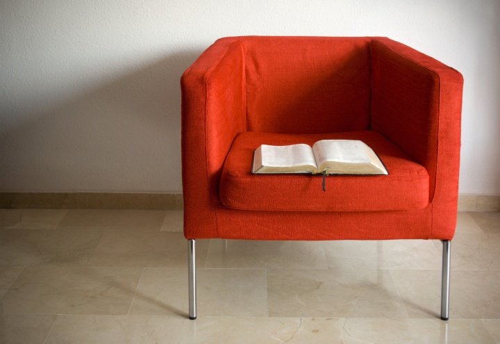 Where are you in regard to worshipping God? Bible laying in an empty red chair.