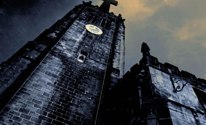 The first major trend prophesied in Revelation is the rise of false teachers claiming to represent Jesus Christ. Old church tower at night.