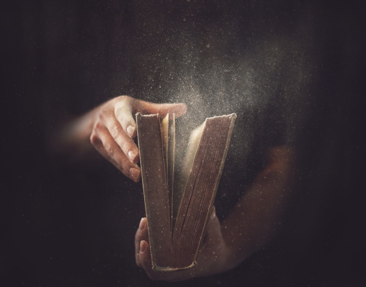 Only those who believe that the Bible is inspired by God and trust what it says will be able to understand the significance of what is revealed in the book of Revelation. A person opening a dusty Bible.