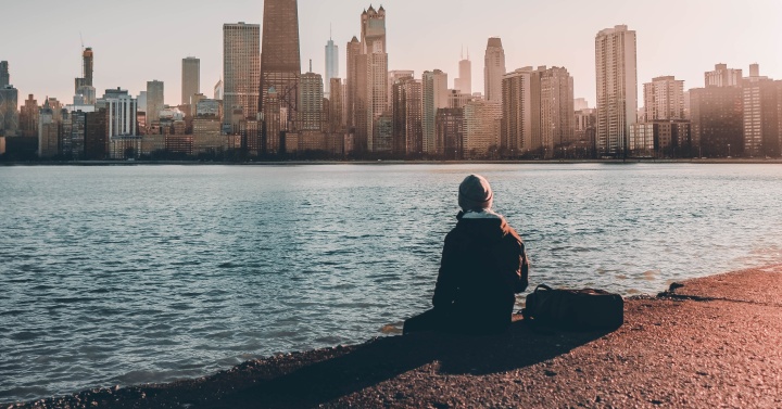 True Christianity is based on the belief that there is absolute truth. A person sitting near the edge of water looking at a city skyline.