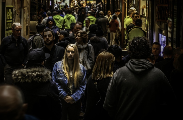 Will you be ready to reject the mark of the Beast, in whatever antibiblical form it takes, when that time comes? A woman walking in a crowded alley with numerous people.